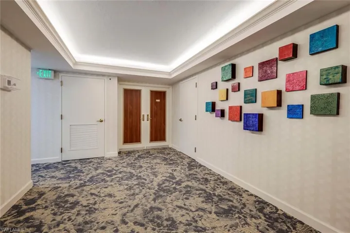 Hallway with a tray ceiling