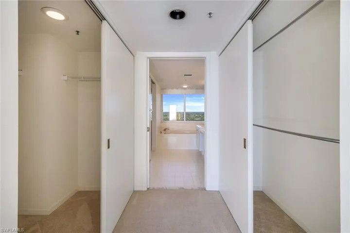 Corridor with light tile patterned floors