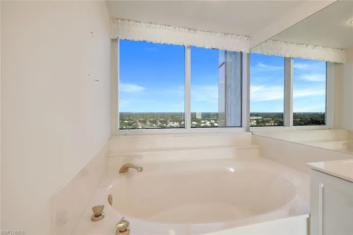 Bathroom featuring vanity and a bath