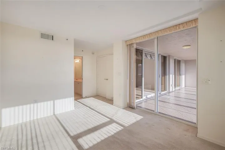 Unfurnished room featuring light colored carpet