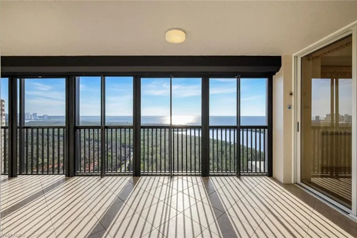 Unfurnished sunroom featuring a healthy amount of sunlight and a water view