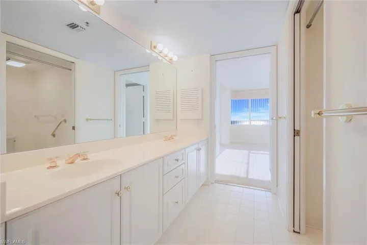 Bathroom with tile patterned floors and vanity