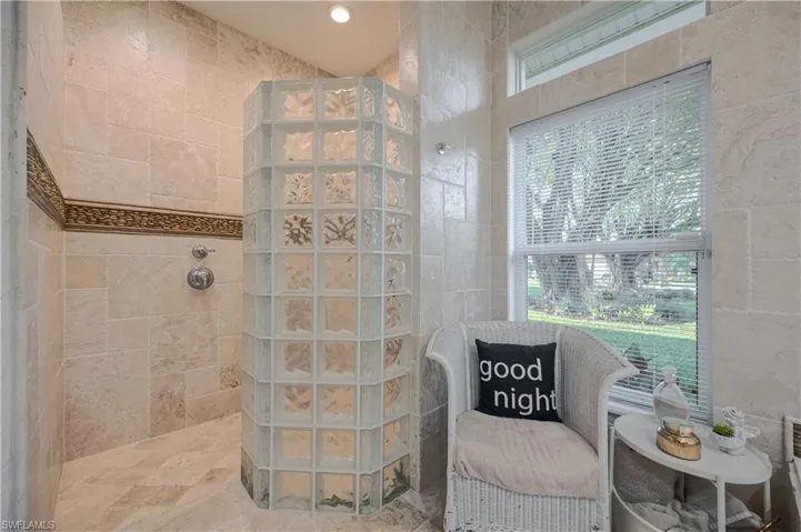Bathroom featuring plenty of natural light and a tile shower