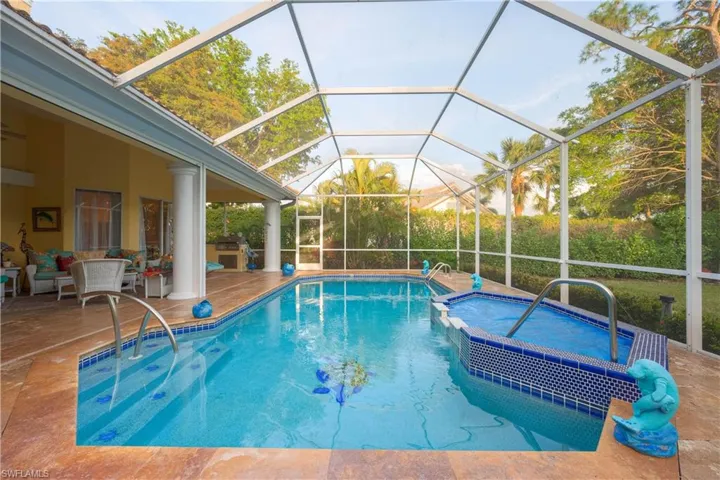 View of pool featuring a lanai, a patio area, and an in ground hot tub