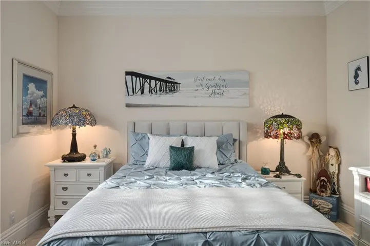 Bedroom with crown molding, window seat, ceiling fan