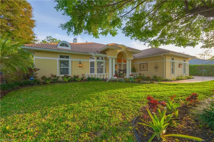 Mediterranean / spanish house with a front yard