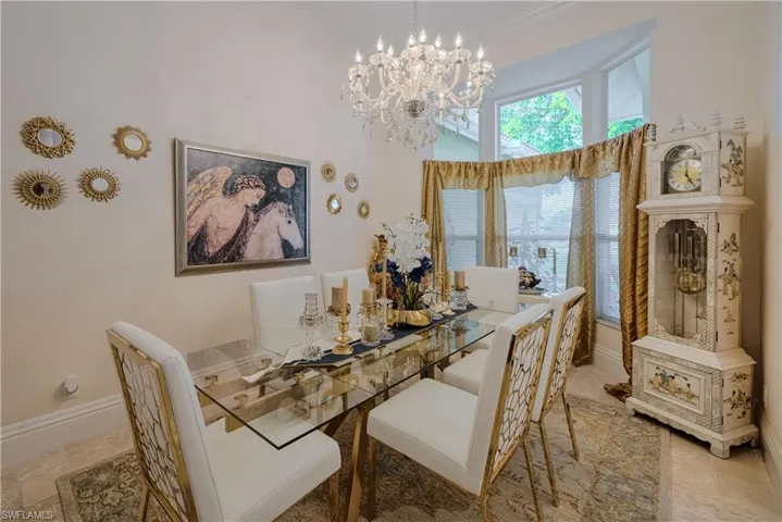 Dining room featuring a high ceiling and an inviting chandelier