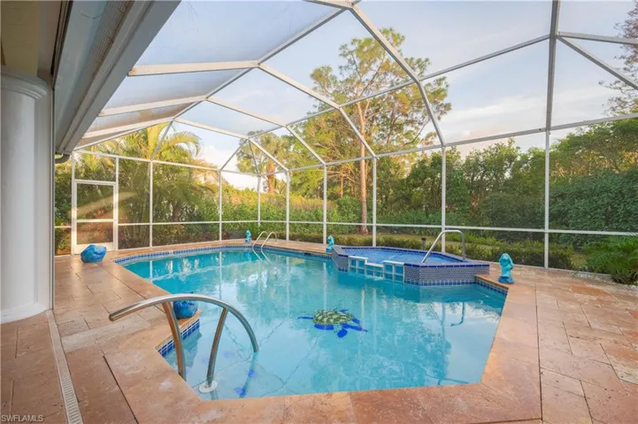 View of pool with an in ground hot tub, a patio, and screen enclosure