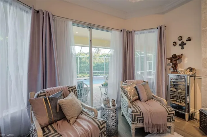 Sitting room with crown molding and hardwood / wood-style flooring