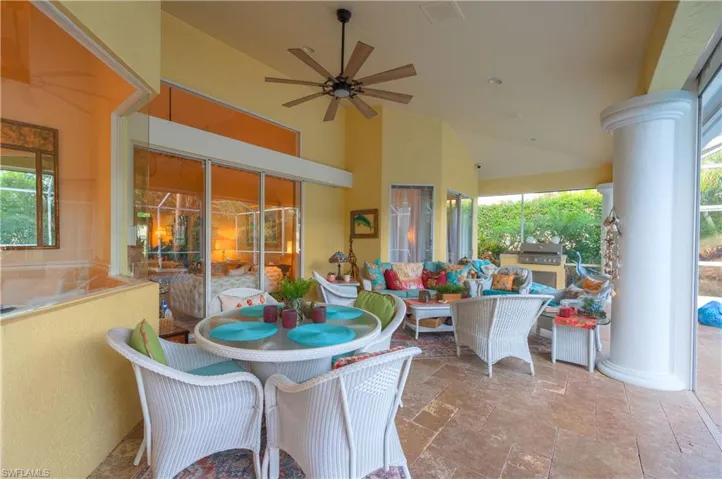View of patio featuring exterior kitchen, a grill, and ceiling fan