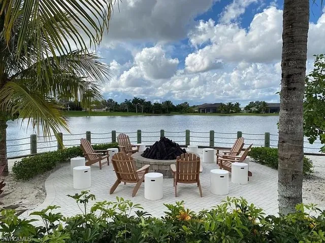 View of patio / terrace with a fire pit and a water view
