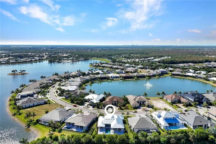 Aerial view of residential area featuring a nearby body of water