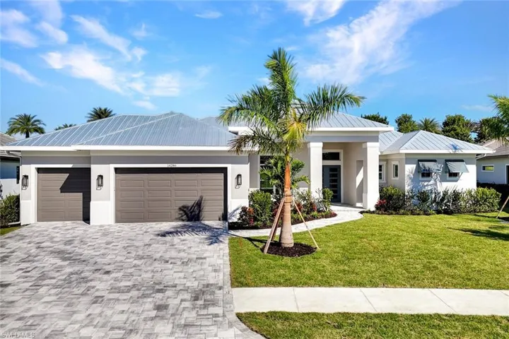 Modern home featuring a front lawn, stucco siding, and an attached garage