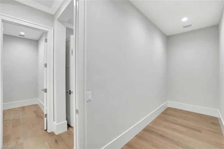 Hallway featuring light wood finished floors and recessed lighting