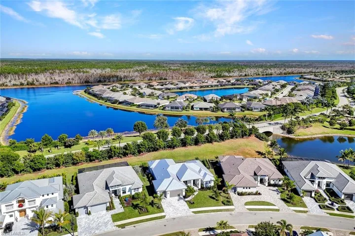 Aerial perspective of suburban area featuring a large body of water
