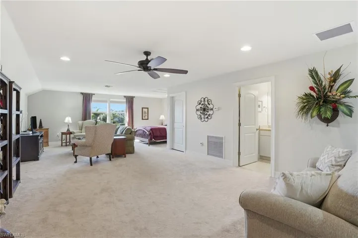 Living room/loft featuring light carpet, recessed lighting, and a ceiling fan