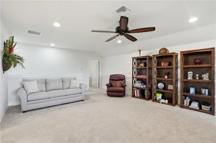 Living area with recessed lighting, a ceiling fan, carpet flooring, and vaulted ceiling