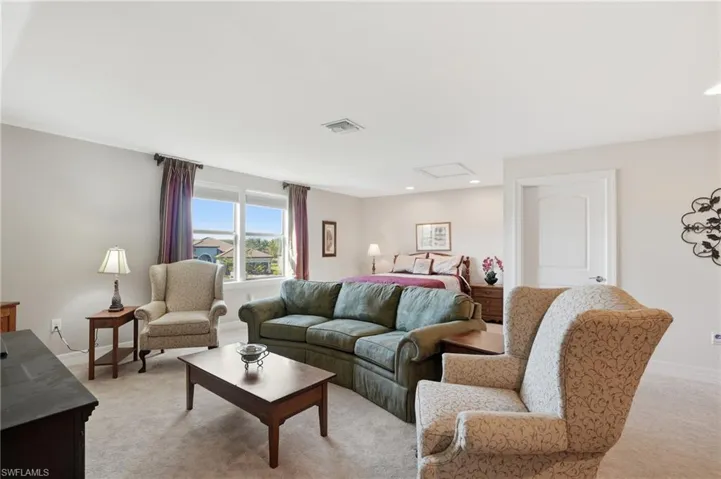 Living room with attic access, light carpet, and recessed lighting