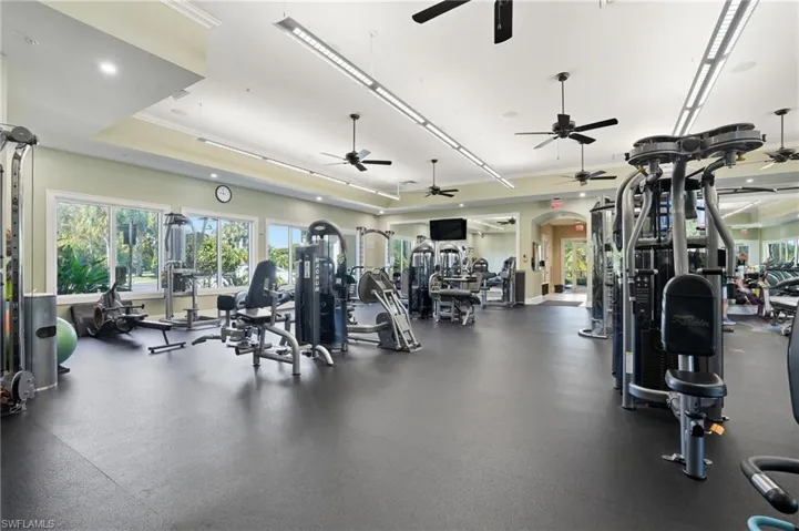 Workout area featuring arched walkways and recessed lighting
