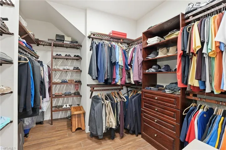 Spacious closet with wood tile finish floors