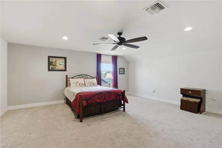Bedroom featuring light carpet, recessed lighting, and a ceiling fan