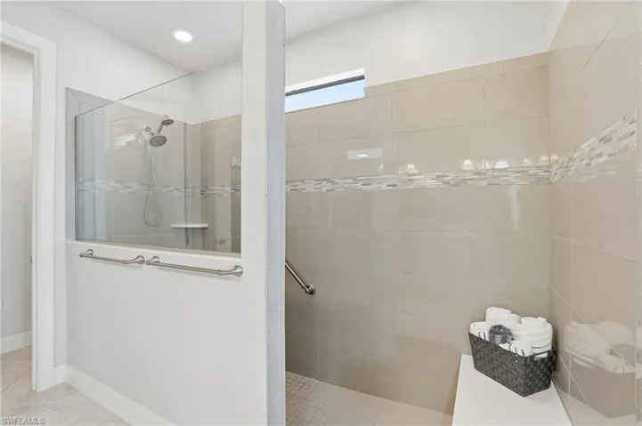 Bathroom with walk in shower and tile patterned flooring