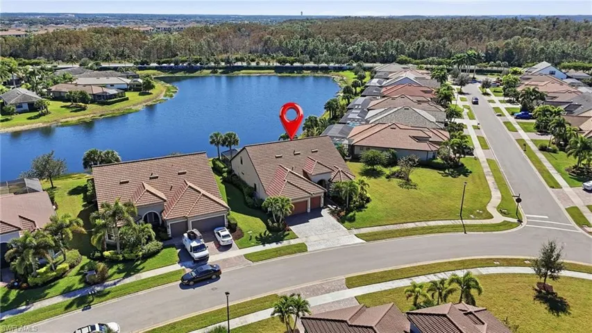 Aerial view of residential area featuring a large body of water