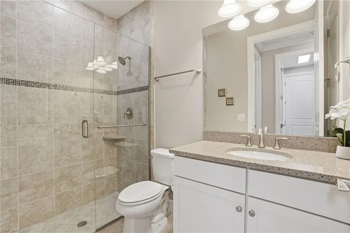 Full bath featuring vanity and a shower stall