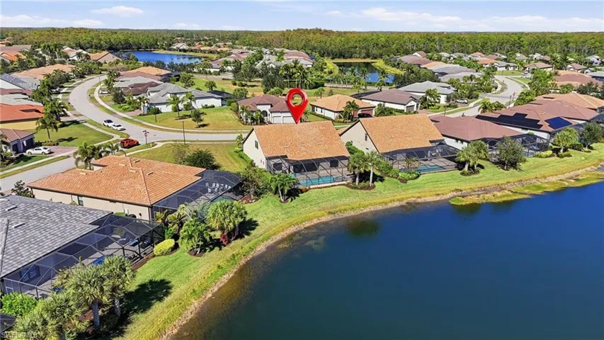 Aerial view of residential area featuring a nearby body of water
