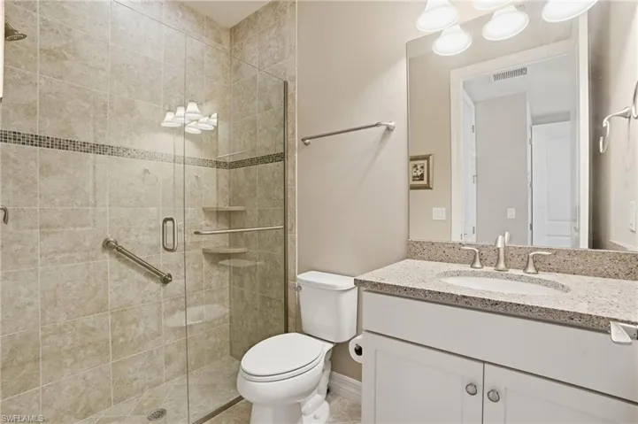 Bathroom featuring vanity and a shower stall