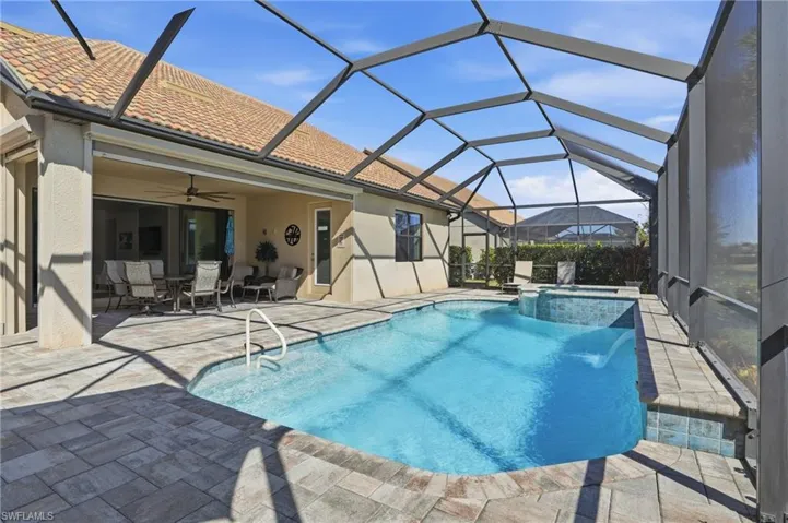 View of swimming pool with a patio, a sunroom, a pool with connected hot tub, a lanai, and a ceiling fan