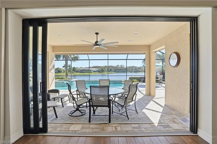 View of patio featuring an outdoor pool, a sunroom, a ceiling fan, and a lanai