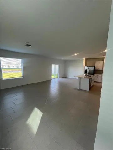Unfurnished living room with light tile patterned floors