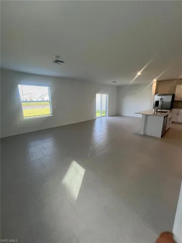 Unfurnished living room with healthy amount of natural light