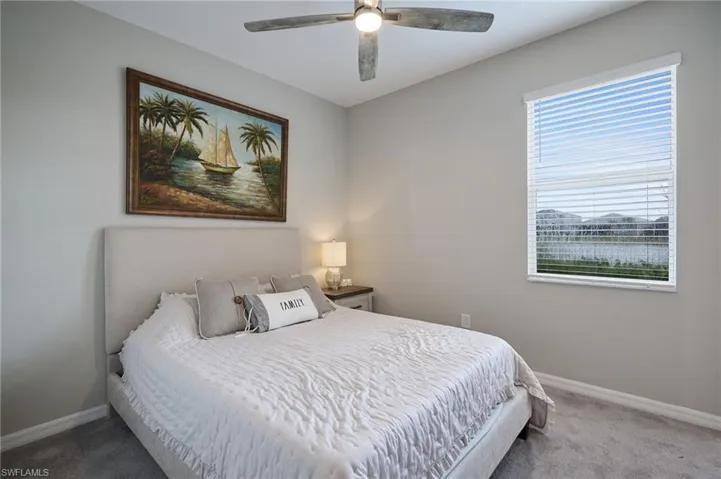 Bedroom featuring ceiling fan and carpet flooring