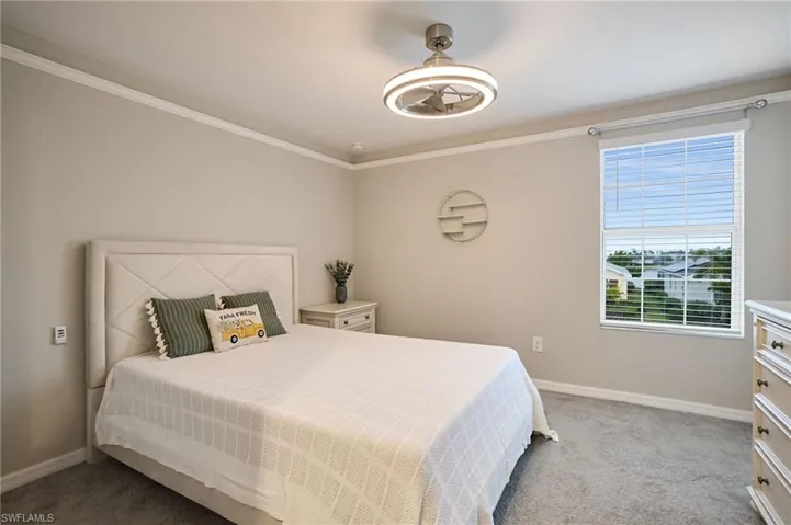 Bedroom featuring carpet flooring and crown molding