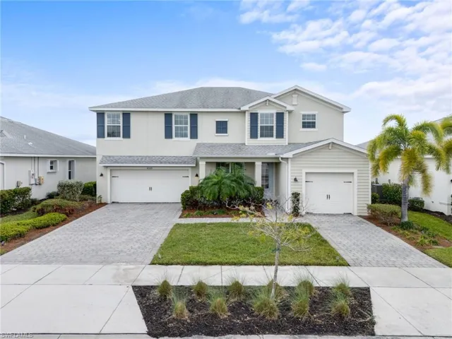 View of front of house with a front yard and a garage