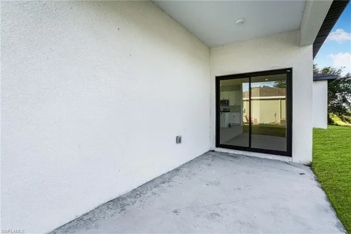 Property entrance with a patio