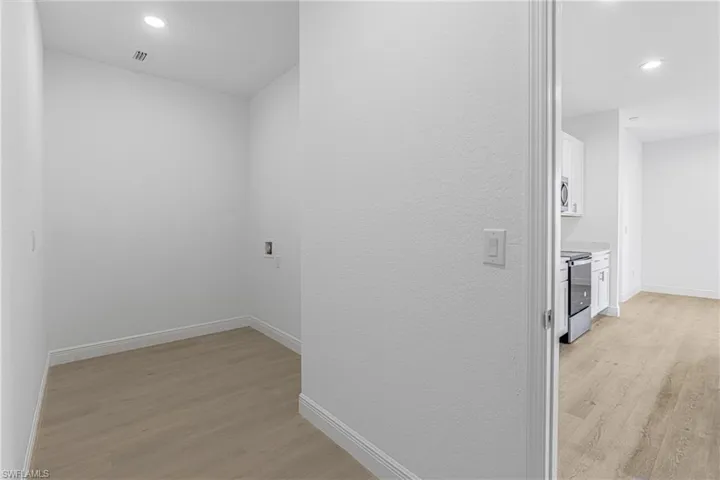 Hallway featuring light wood-type flooring