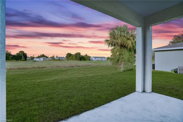 Yard at dusk featuring a patio