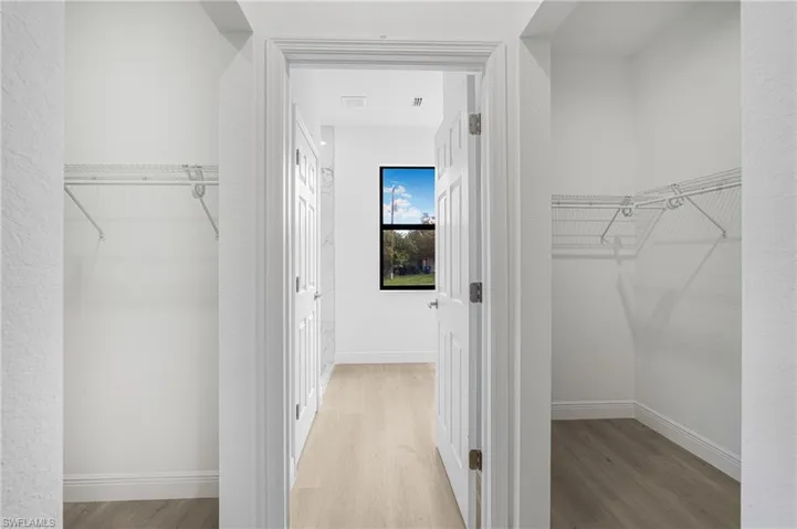 Walk in closet featuring light hardwood / wood-style floors