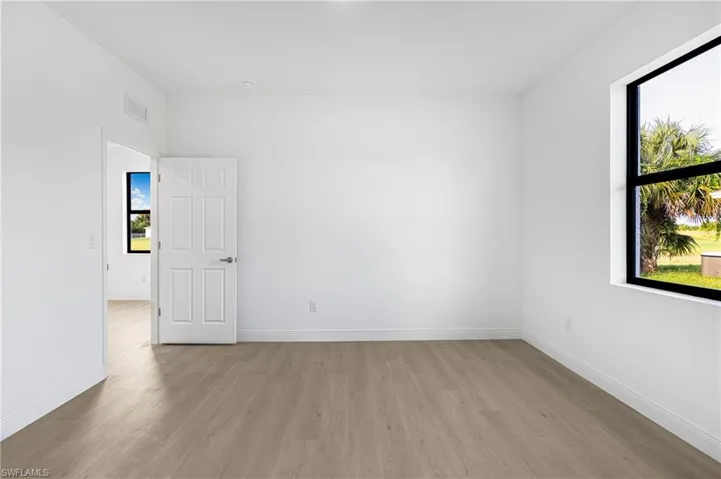 Unfurnished room featuring a wealth of natural light and light wood-type flooring