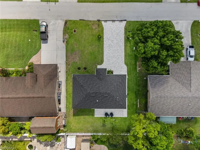 Overhead perspective showcasing a residential property with a dark shingle roof