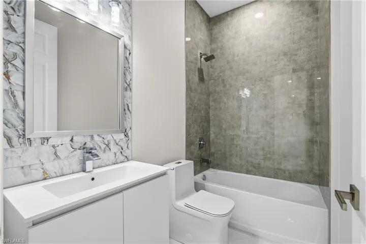 Bathroom with vanity and shower / tub combination
