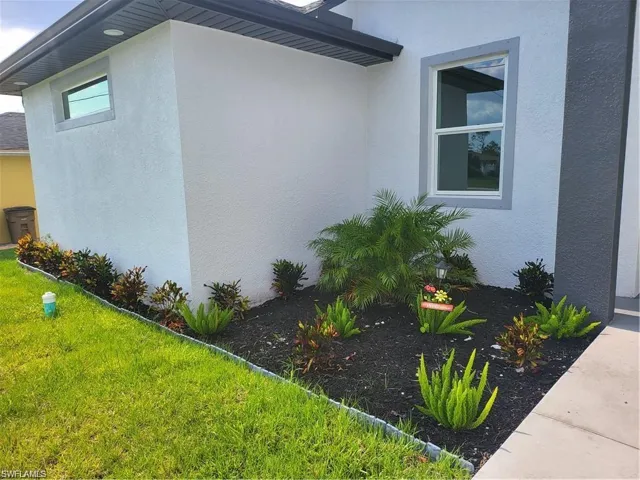 View of property exterior with a lawn