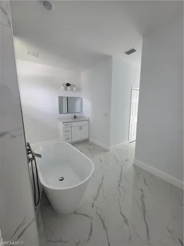 Bathroom featuring vanity and a bathtub
