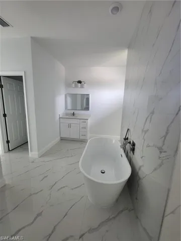 Bathroom featuring vanity and a bathtub