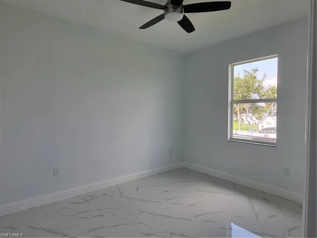 Empty room featuring ceiling fan