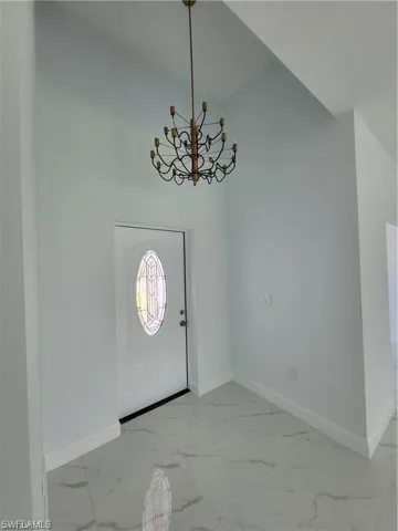 Entrance foyer featuring a notable chandelier