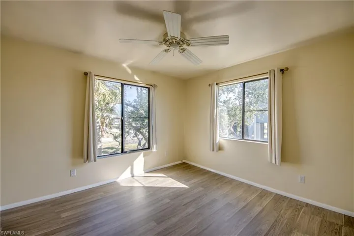 Unfurnished room featuring hardwood / wood-style flooring and ceiling fan